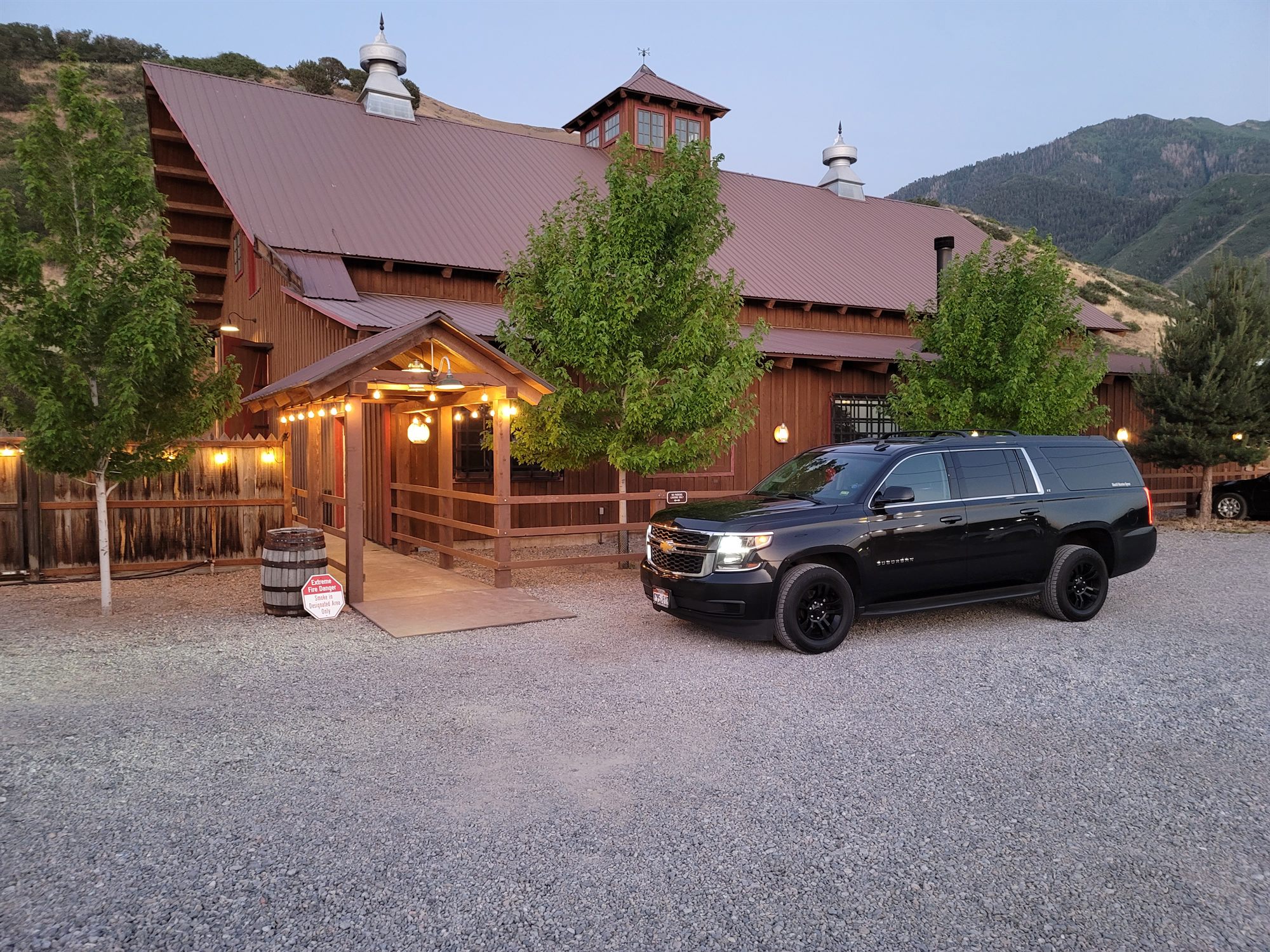 The SUV outside a barn wedding venue at dusk