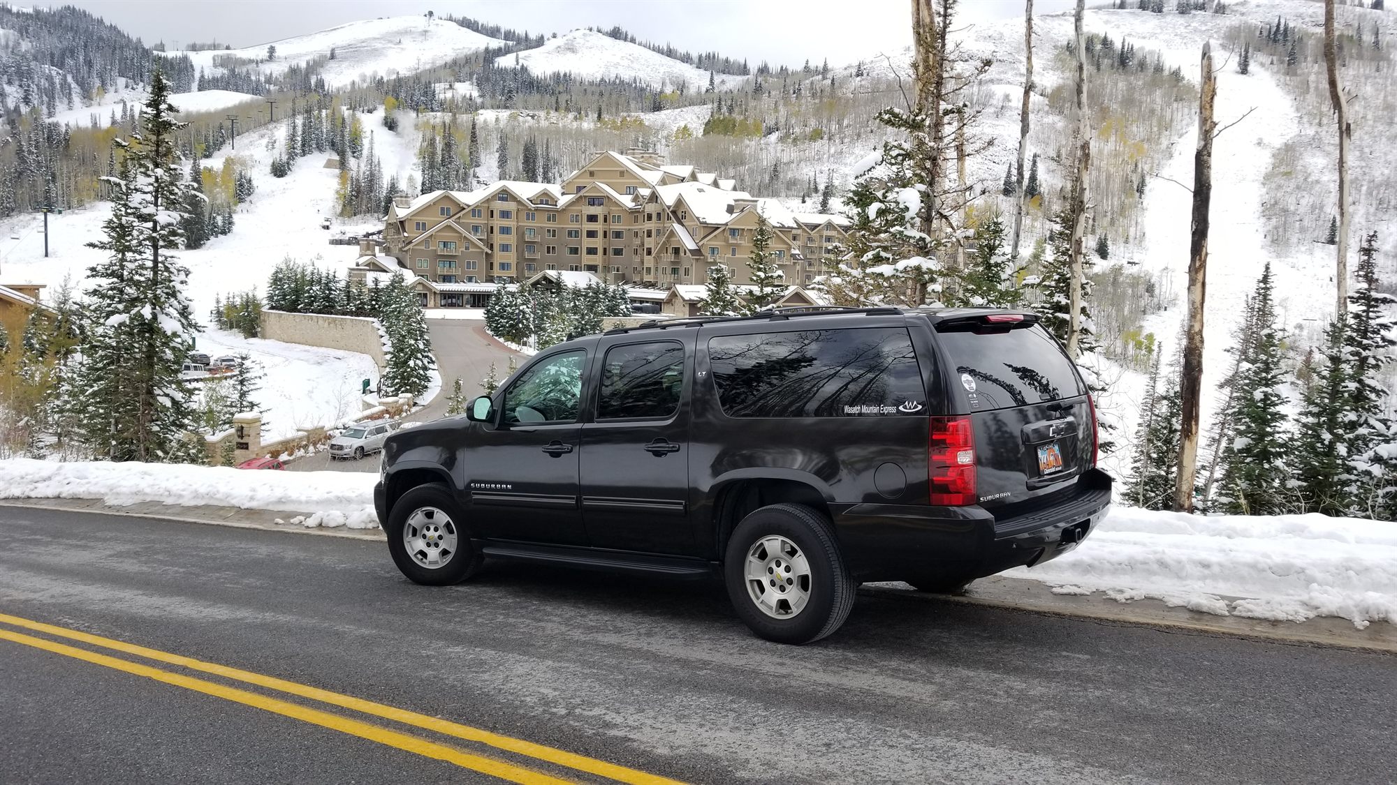 The SUV on the approach road to a Deer Valley resort in fresh snow