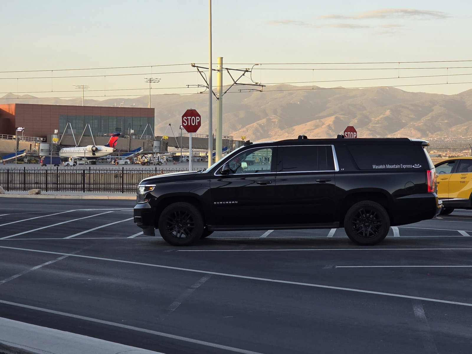 The SUV at Salt Lake City International at sunset, with aircraft on the ramp and the Wasatch Front behind