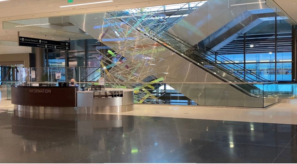The escalator down to the ground floor at Salt Lake City International, beside the information desk