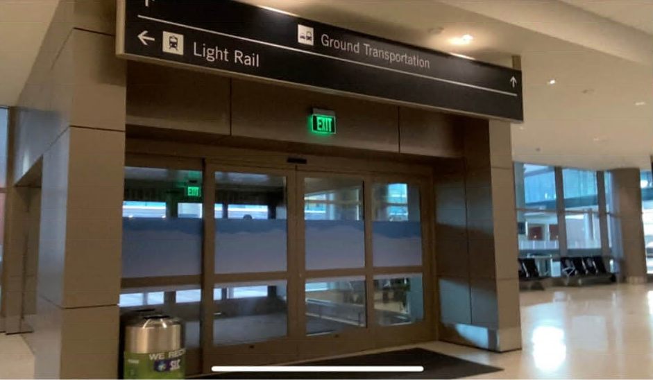 The doors at Salt Lake City International signed Ground Transportation, with Light Rail signed to the left